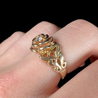 A ladies' yellow gold rose style ring set with a natural 0.10ct diamond.