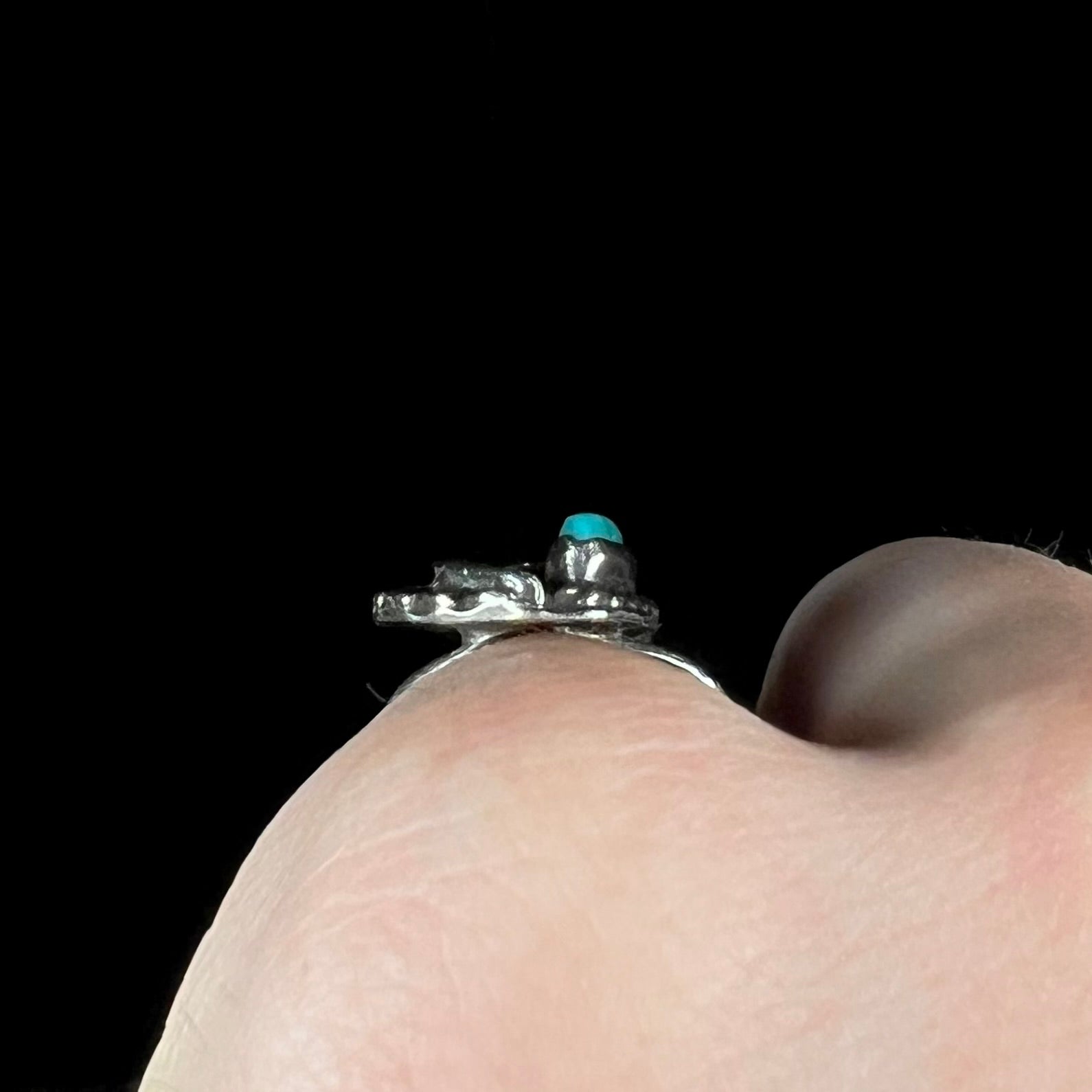 A ladies' sterling silver feather style ring set with a marquise cut turquoise stone.