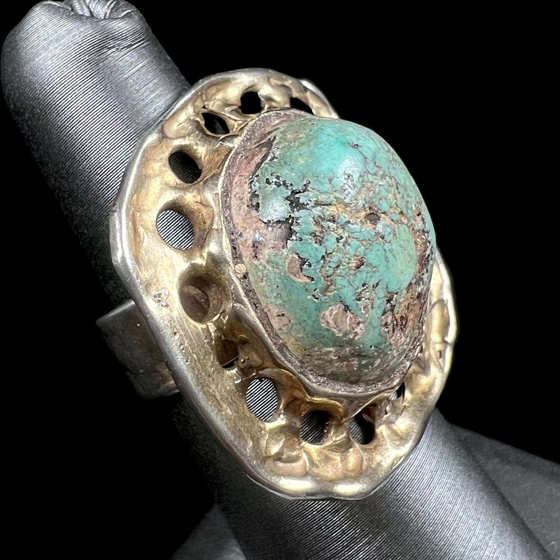 A unisex sterling silver ring with a gold wash, set with a natural, unstabilized Valley Blue turquoise stone.