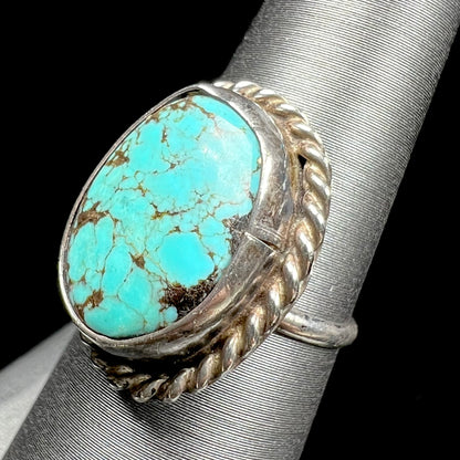 A handmade ladies' turquoise solitaire ring.  The ring has a rope bezel design.