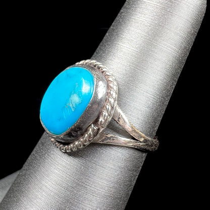 A vintage ladies' Pilot Mountain turquoise ring handmade in sterling silver with a rope accented bezel.