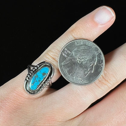 A handmade sterling silver Navajo style ring set with a Morenci turquoise stone.