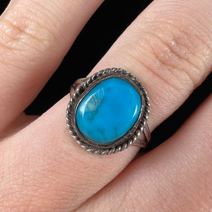 A vintage ladies' Pilot Mountain turquoise ring handmade in sterling silver with a rope accented bezel.