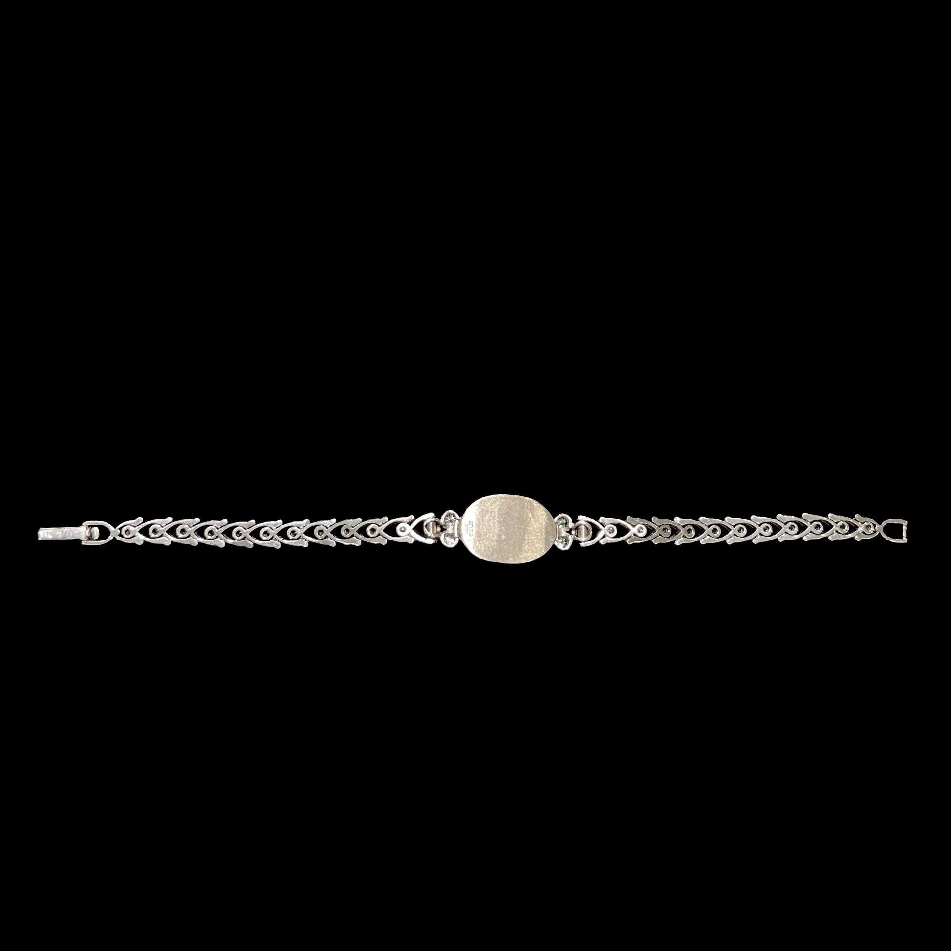 A ladies' vintage, 1930's natural opal bracelet set with accent diamonds in white gold.