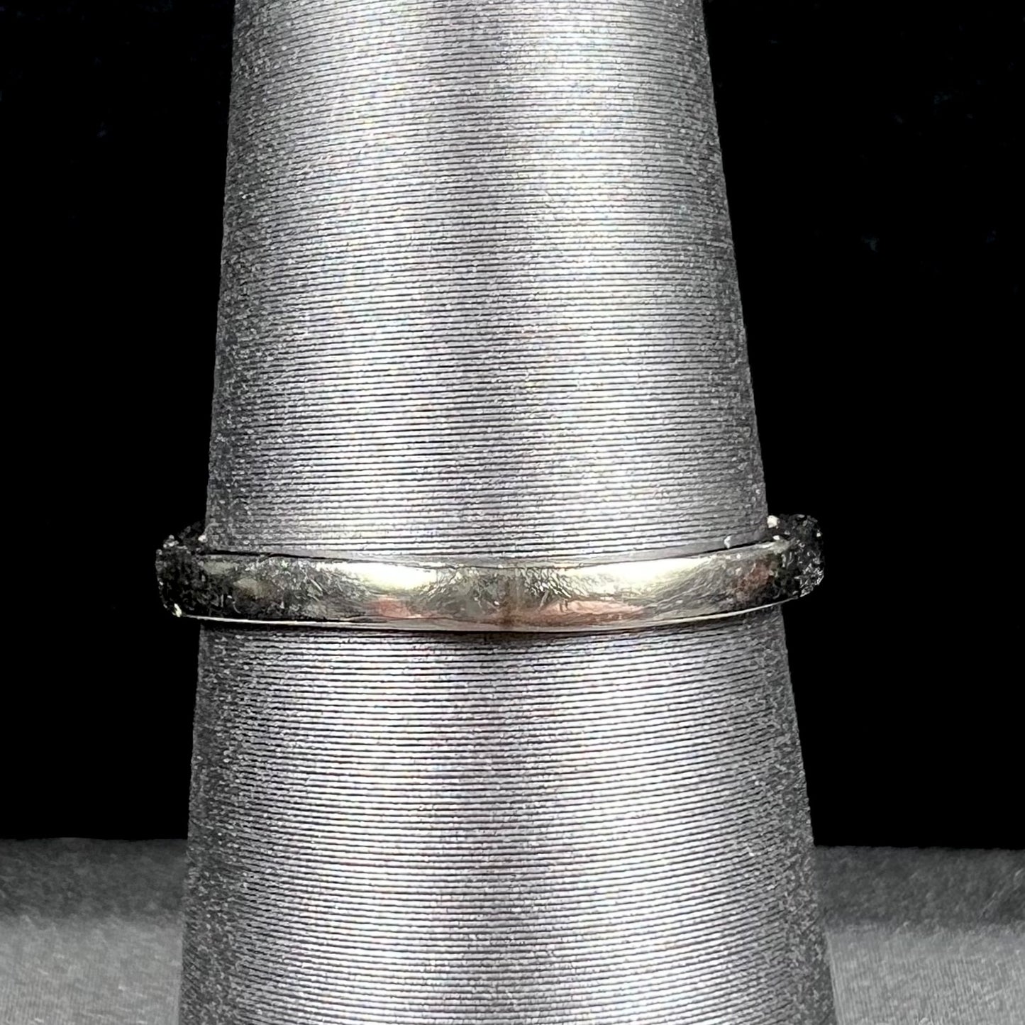A ladies' estate white gold ruby ring set with a diamond accent stone.