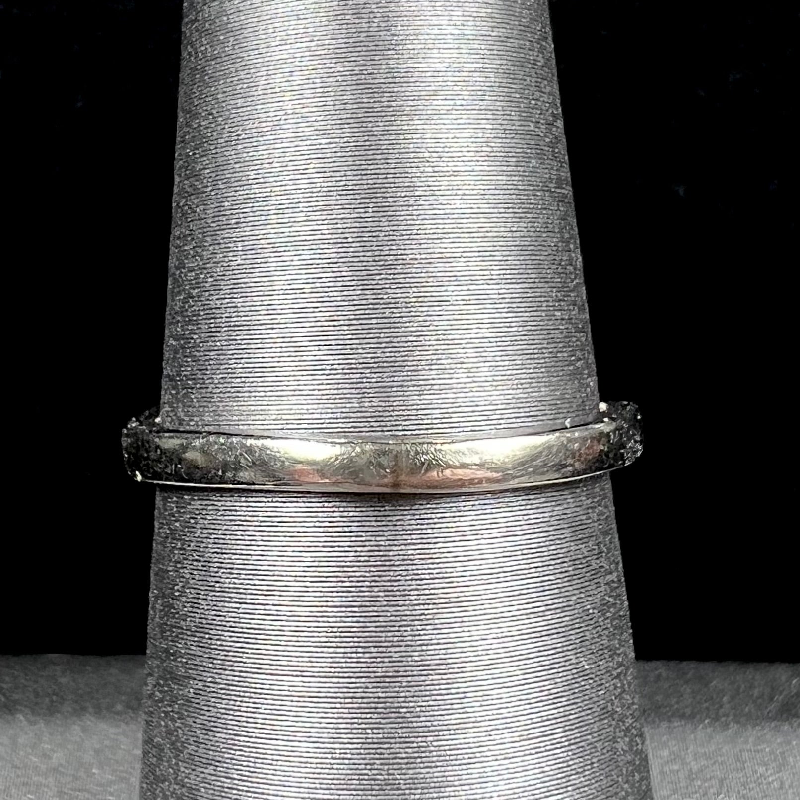 A ladies' estate white gold ruby ring set with a diamond accent stone.