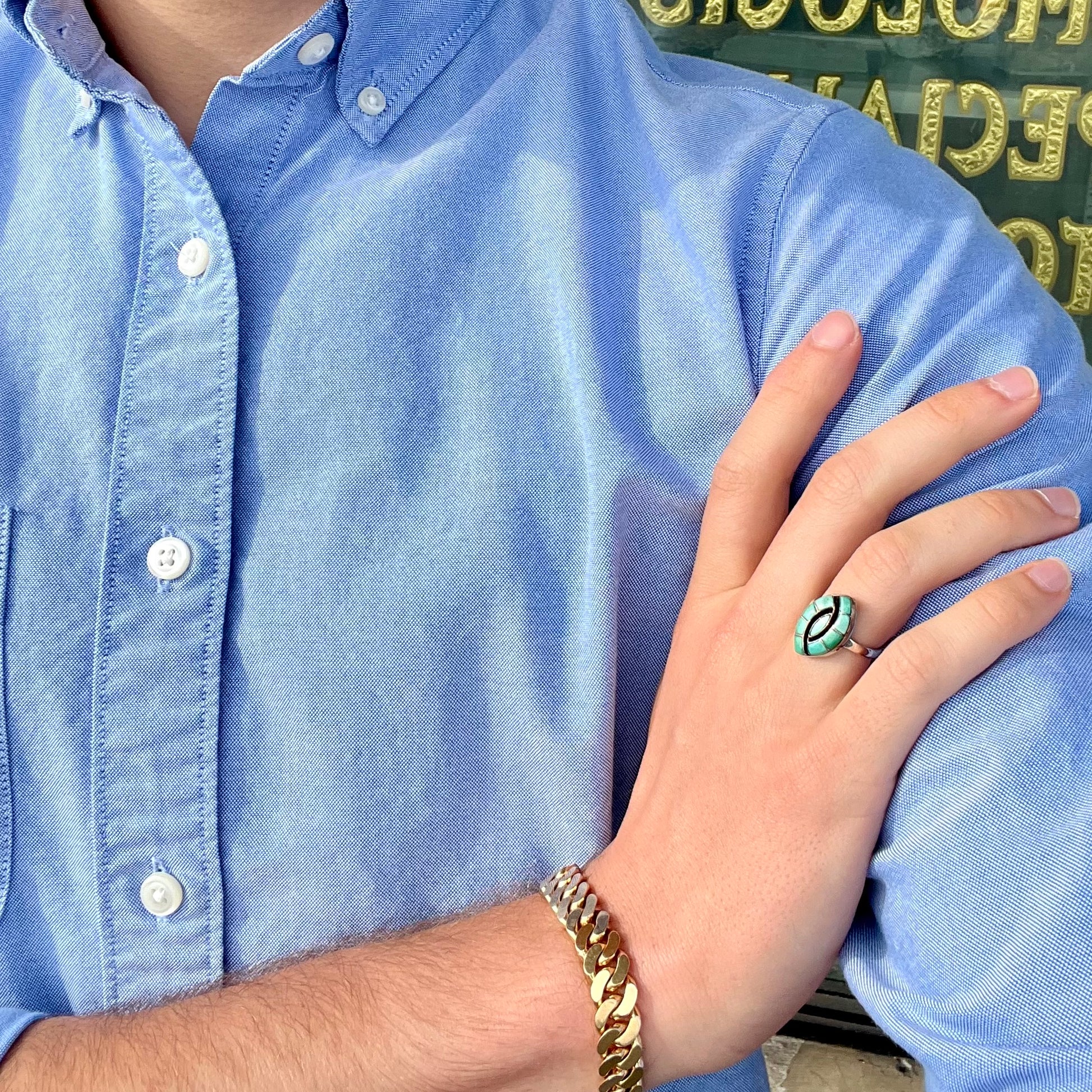 Vintage sterling silver Zuni Indian ring inlay set with green turquoise stones in the motif of a hummingbird.