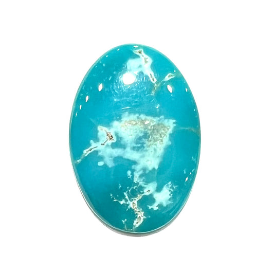 An electric blue Pilot Mountain turquosie stone from Nevada.  The turquoise is cut into an oval shaped cabochon.