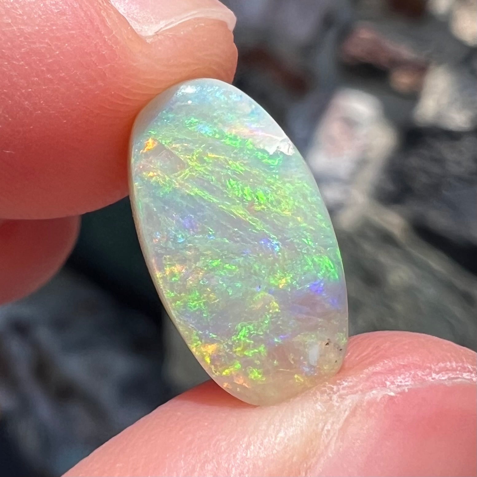 A loose, Lightning Ridge light crystal opal.  The opal is predominantly green.