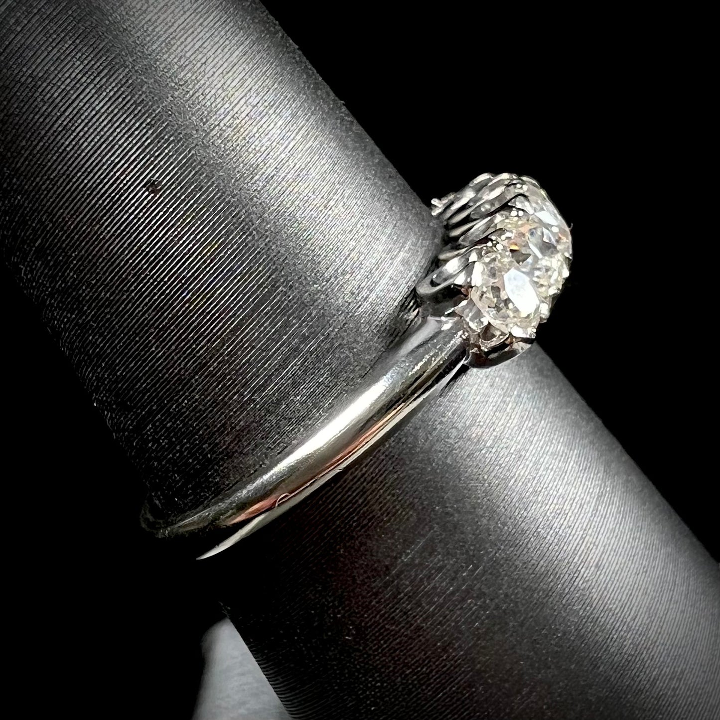 An antique white gold diamond wedding band set with six old mine cut natural diamonds.