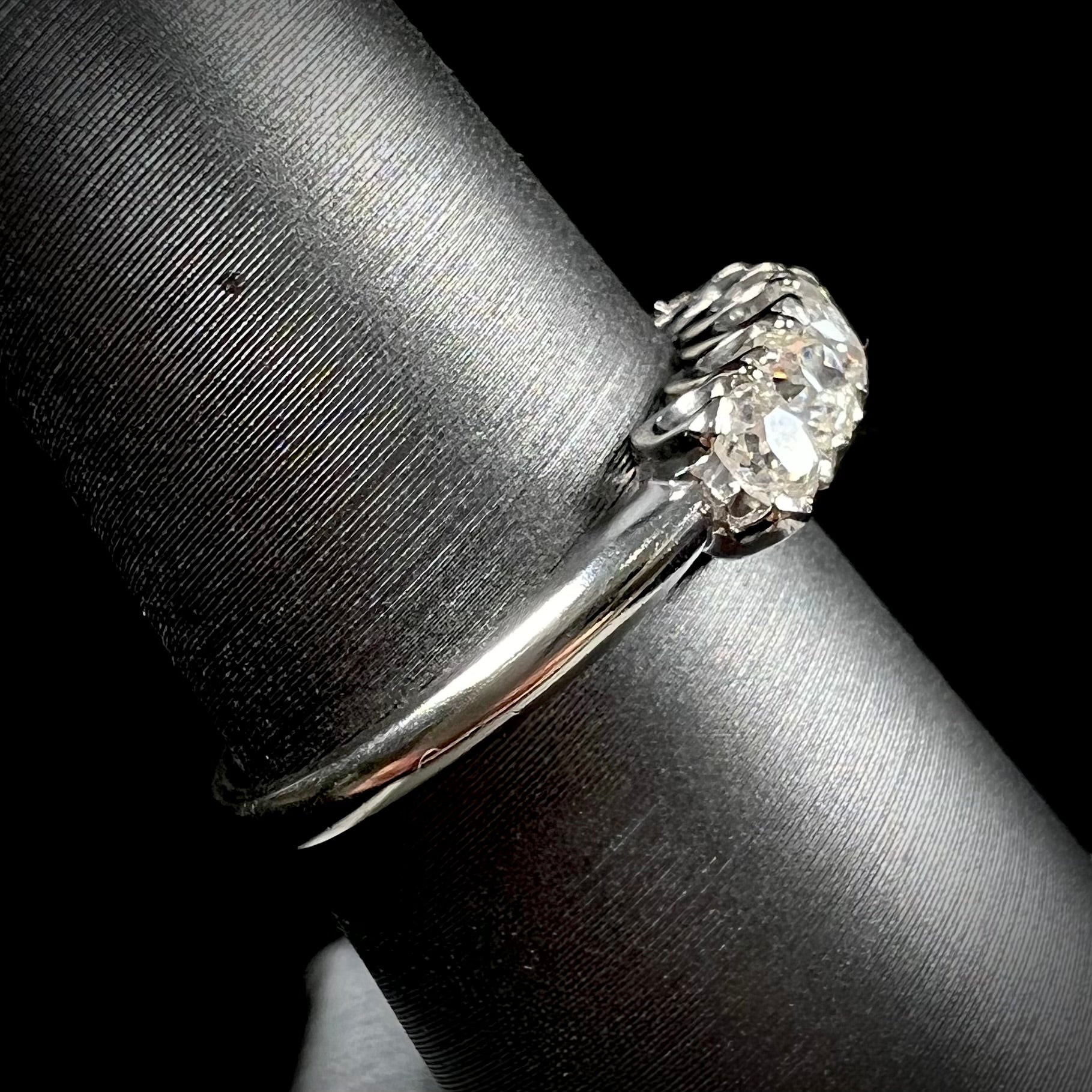 An antique white gold diamond wedding band set with six old mine cut natural diamonds.
