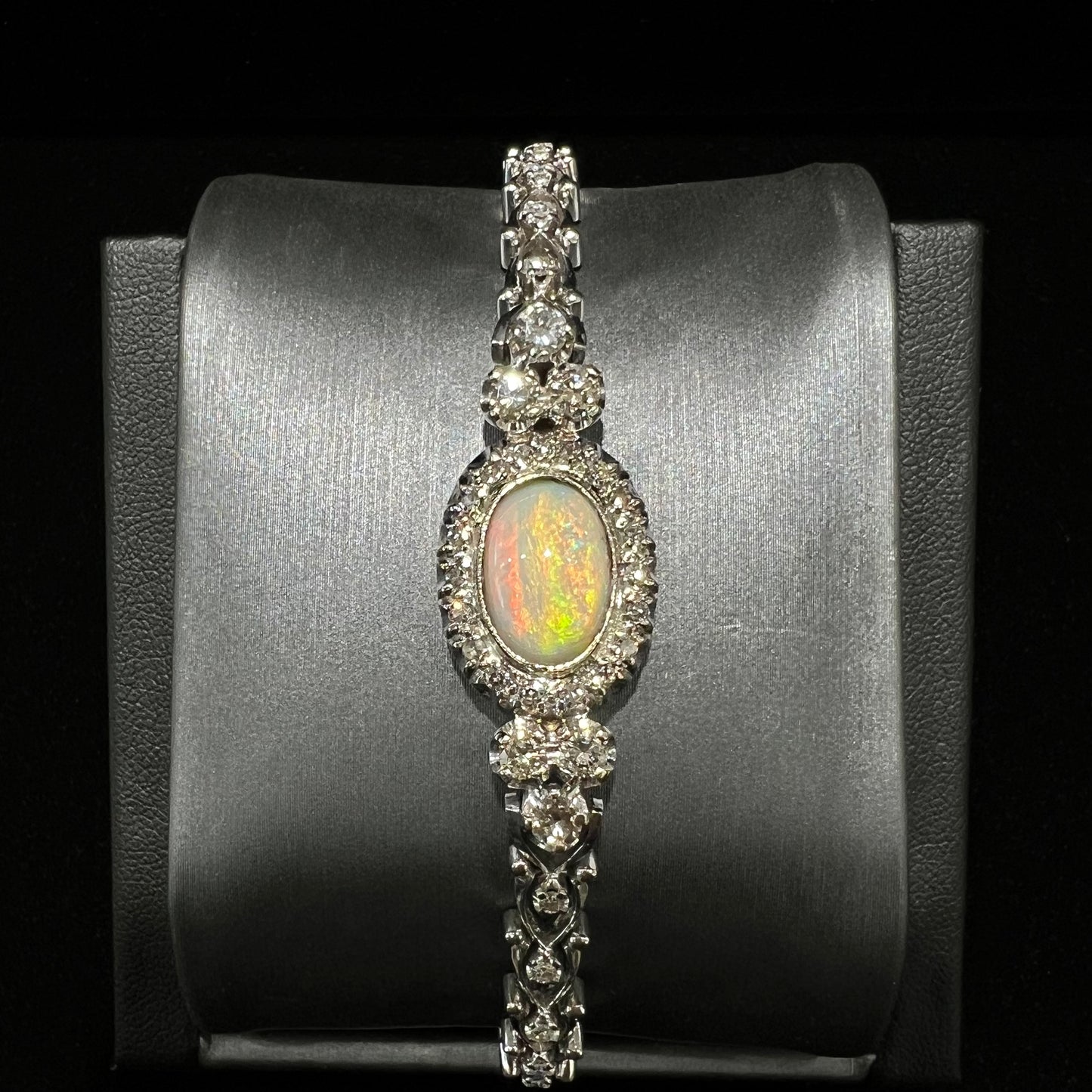 A ladies' vintage, 1930's natural opal bracelet set with accent diamonds in white gold.