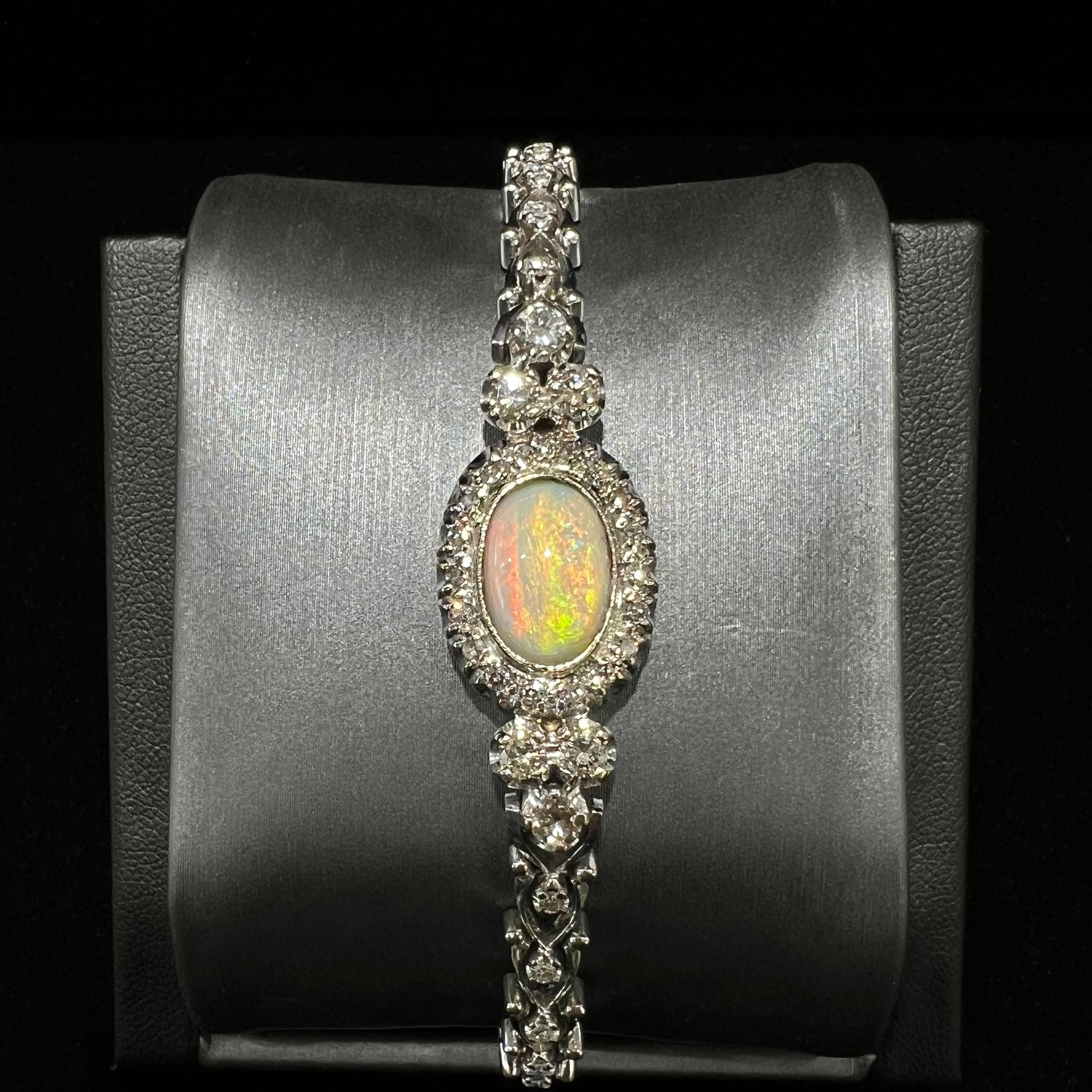 A ladies' vintage, 1930's natural opal bracelet set with accent diamonds in white gold.