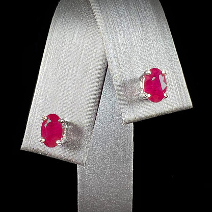 A pair of natural Burma ruby stud earrings set in white gold.  The rubies are a purplish red color.