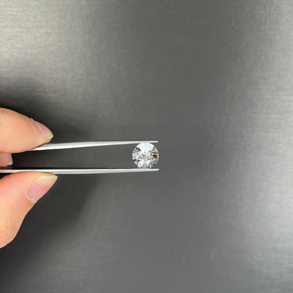 A round brilliant cut petalite gemstone.  The stone is colorless.