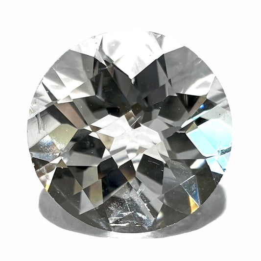 A loose, round checkerboard cut white topaz gemstone.  The stone weighs 4.51 carats.