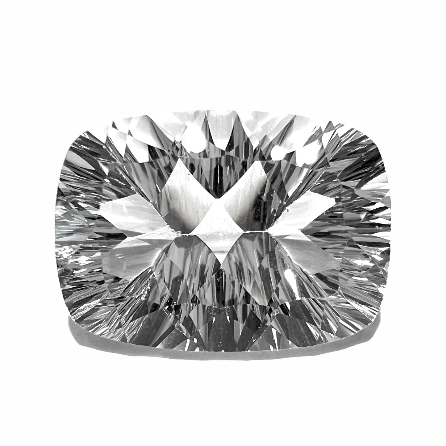 A loose, cushion laser cut white topaz stone.