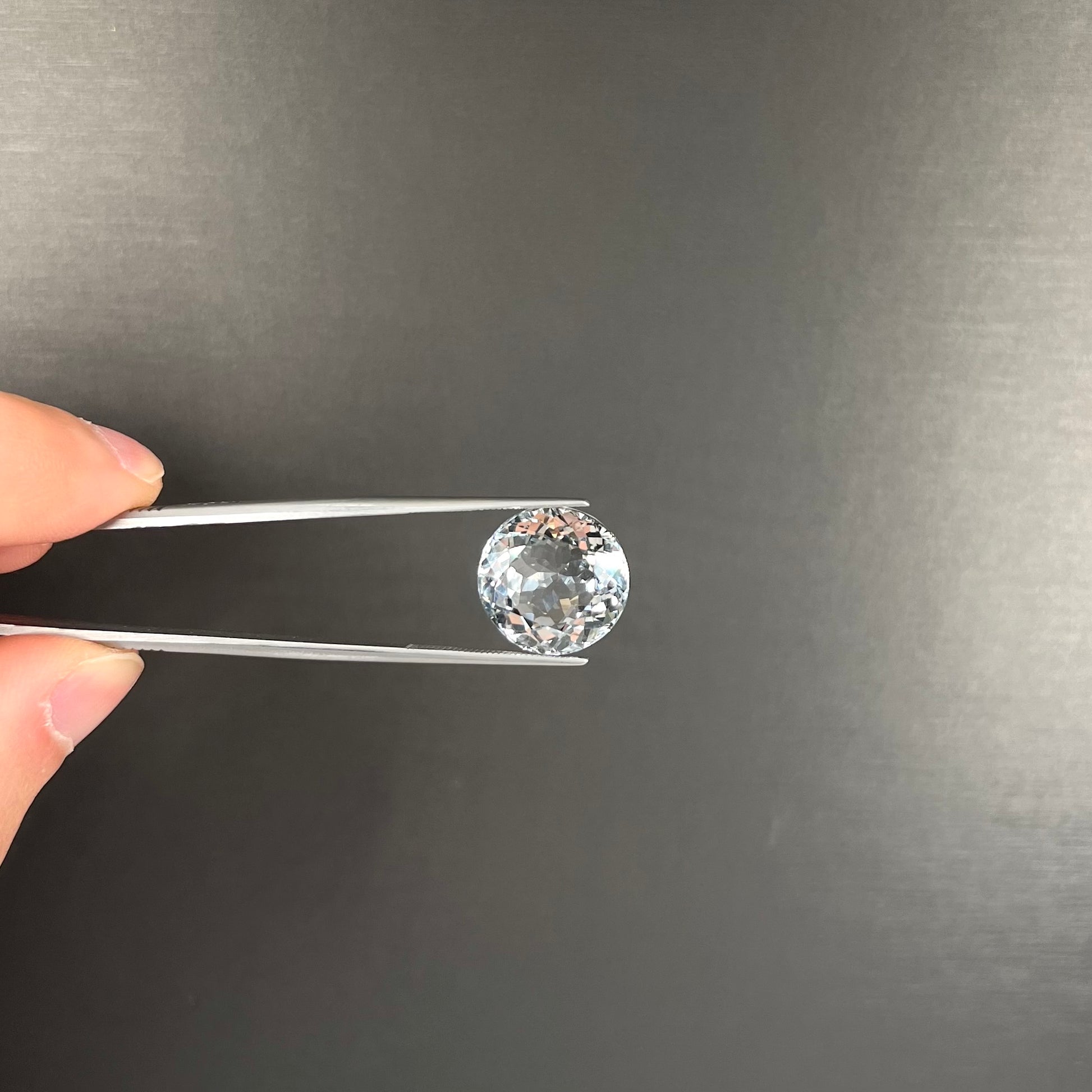A large, round brilliant cut white topaz gemstone.