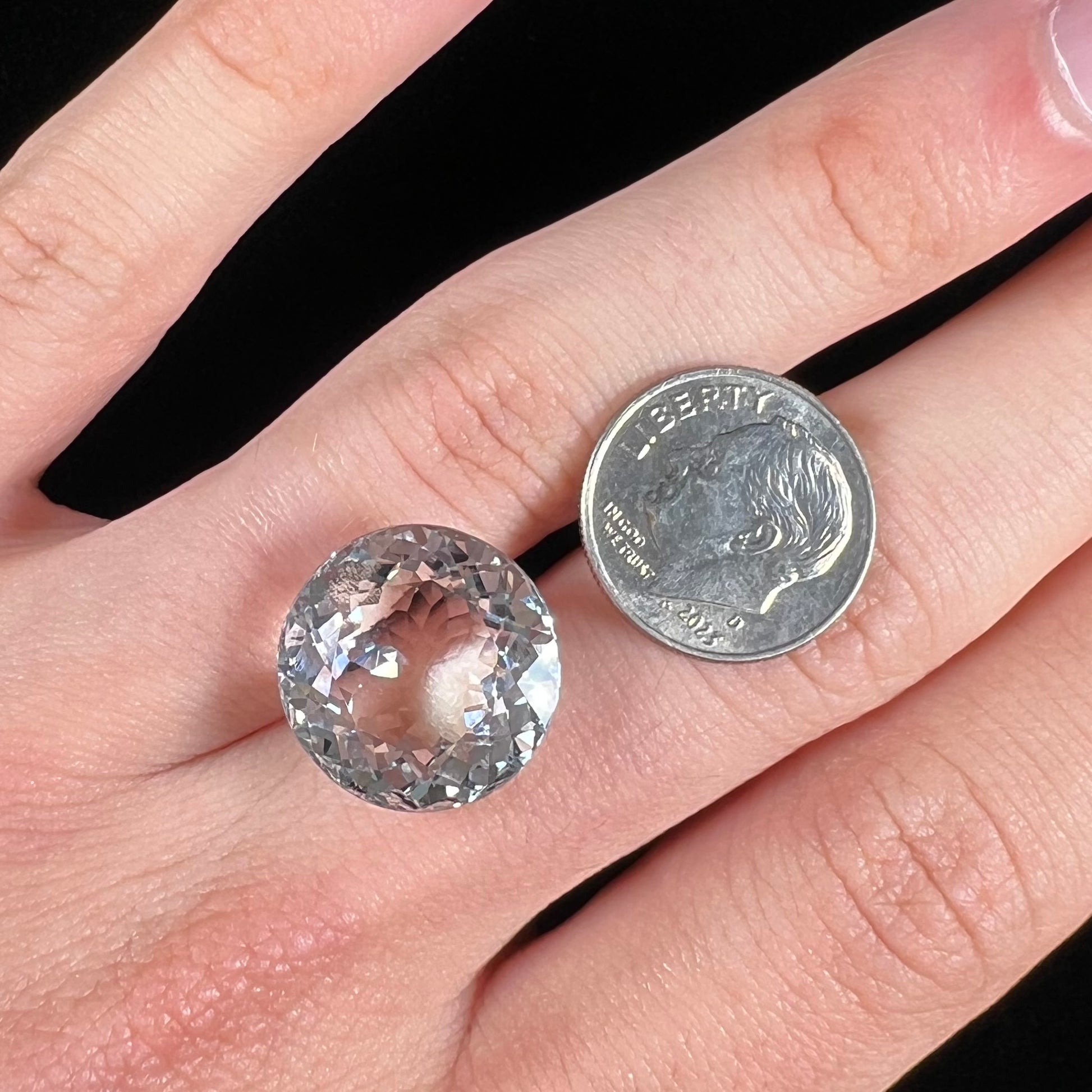 A large, round brilliant cut white topaz gemstone.