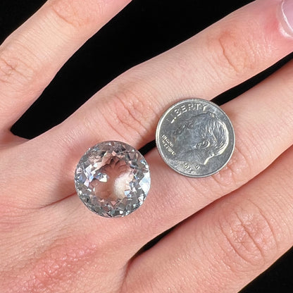 A large, round brilliant cut white topaz gemstone.