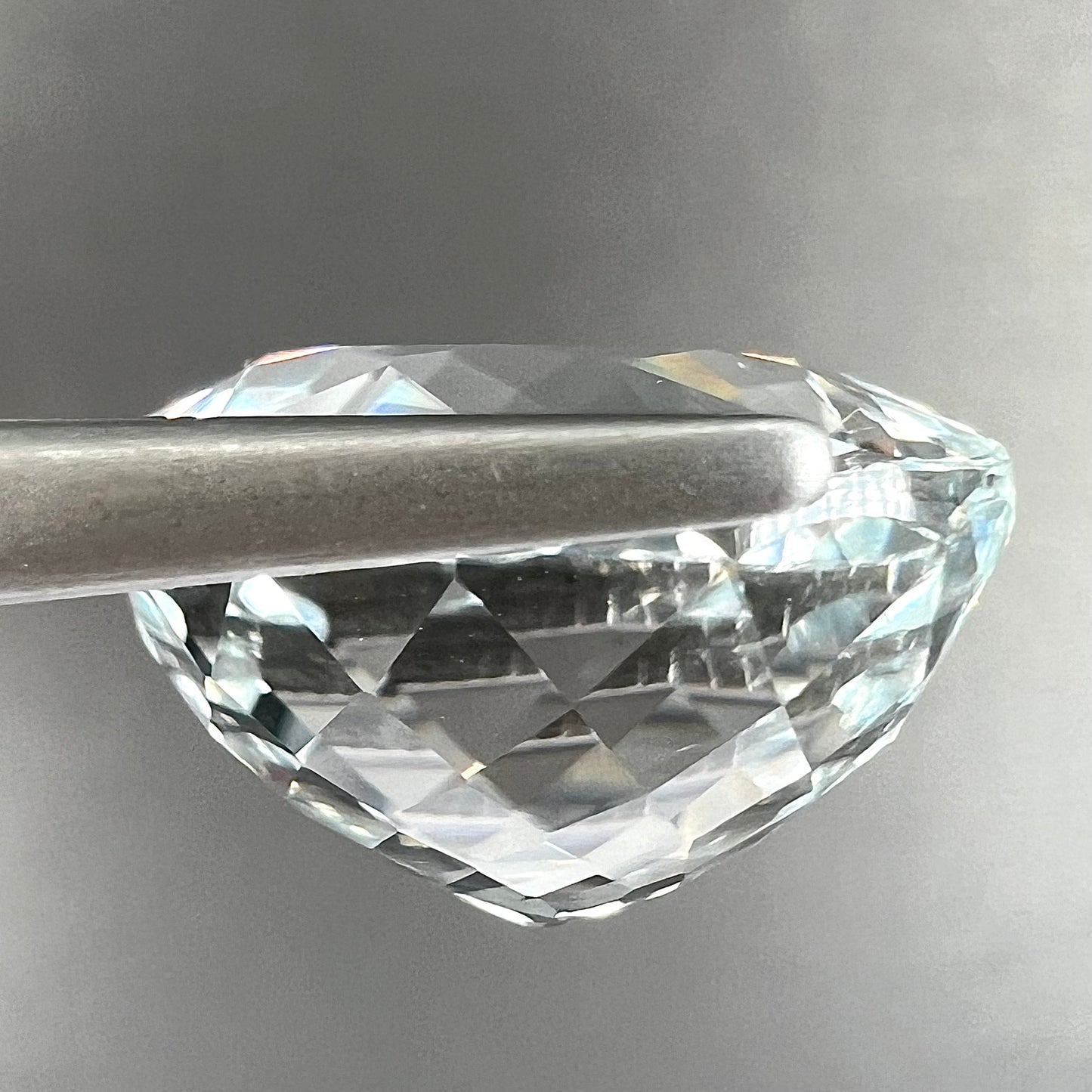A large, round brilliant cut white topaz gemstone.