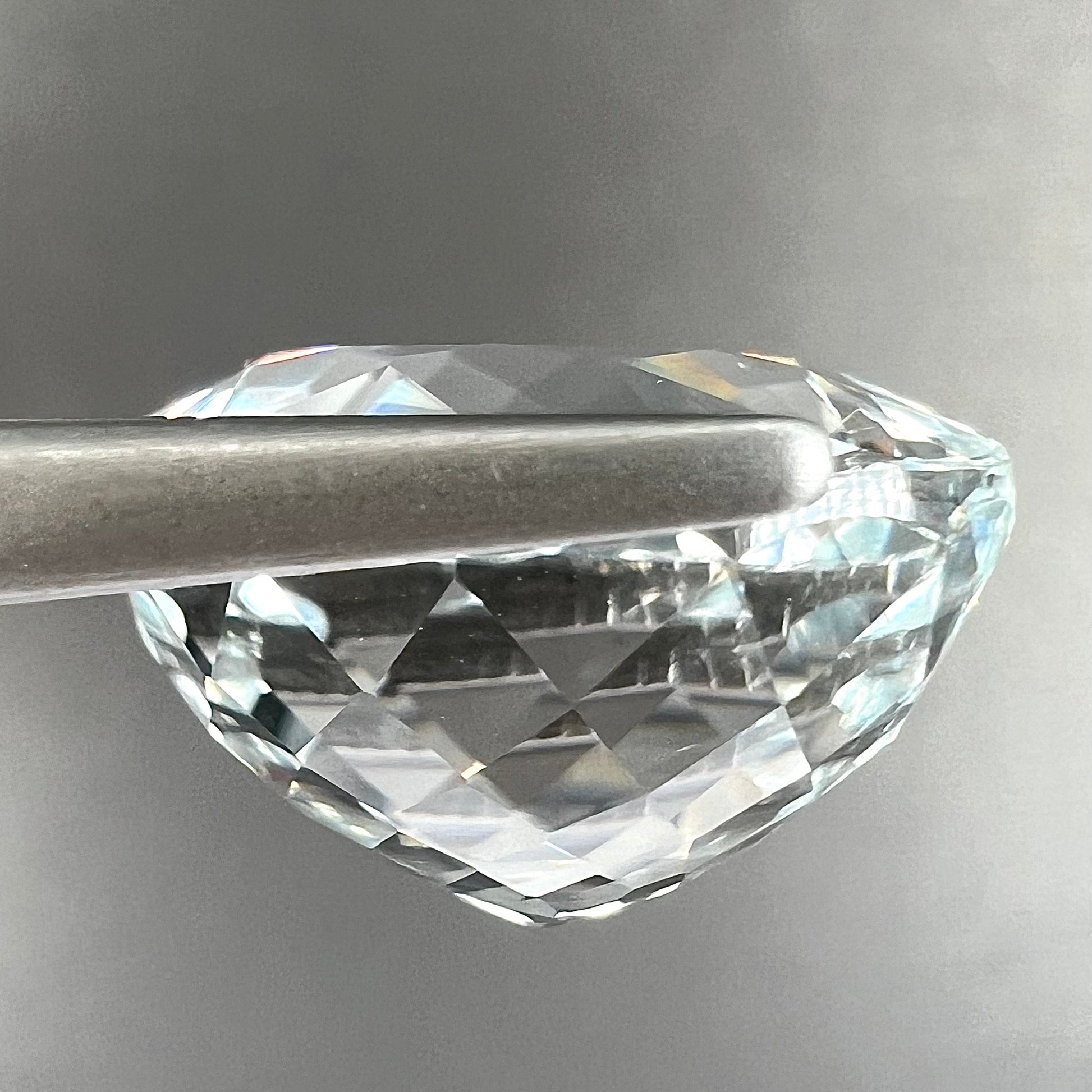 A large, round brilliant cut white topaz gemstone.
