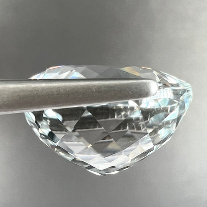 A large, round brilliant cut white topaz gemstone.