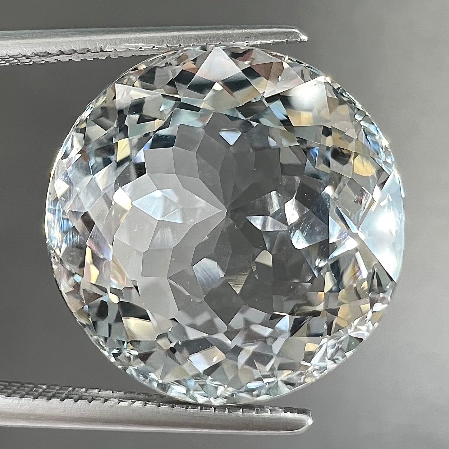 A large, round brilliant cut white topaz gemstone.