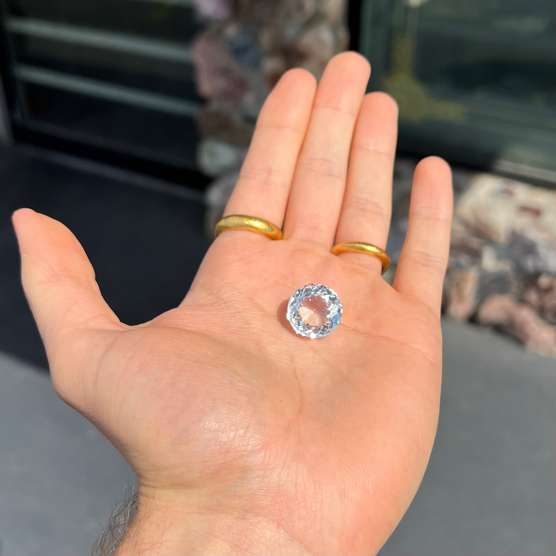 A large, round brilliant cut white topaz gemstone.