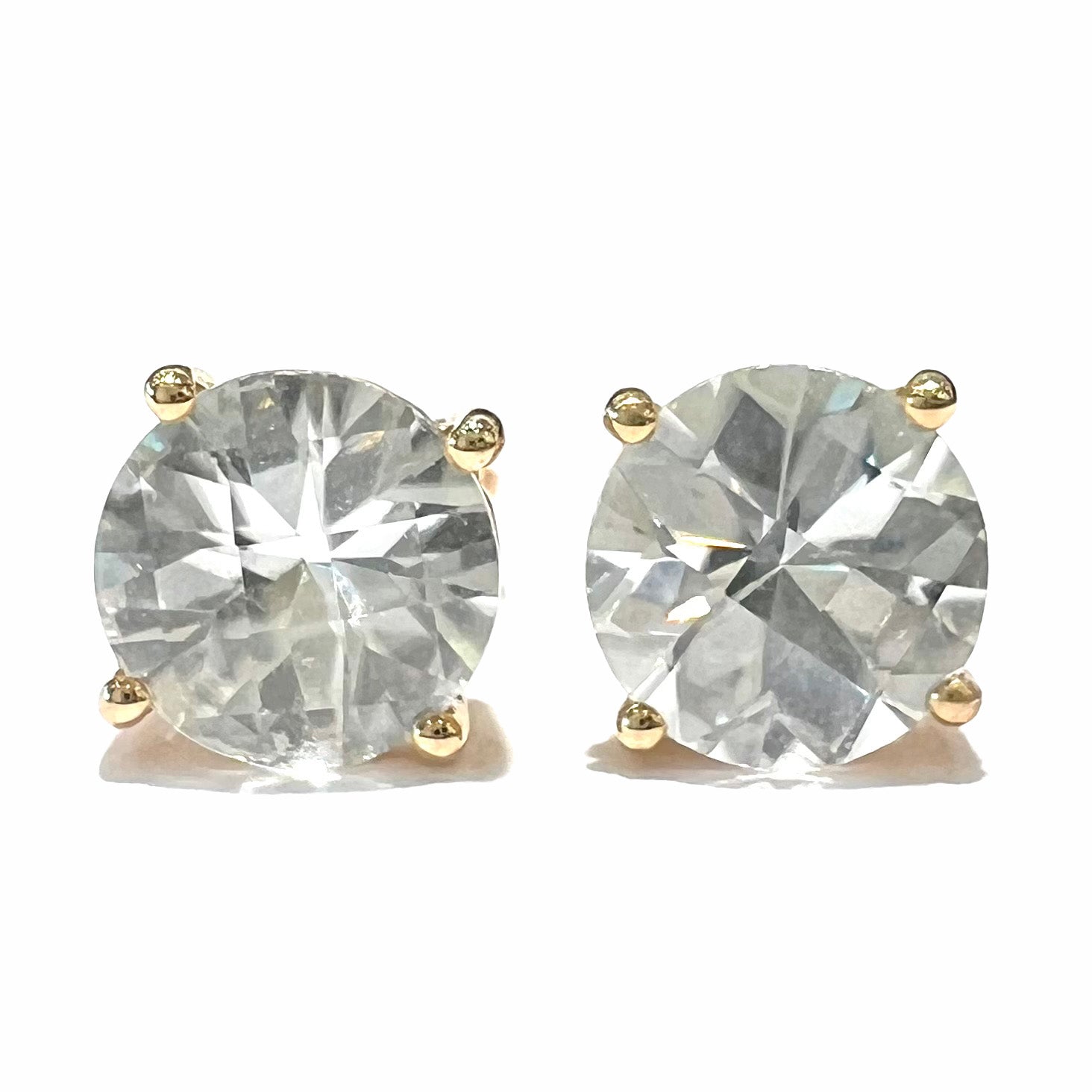 A pair of checkerboard round brilliant cut white zircon stud earrings in yellow gold.