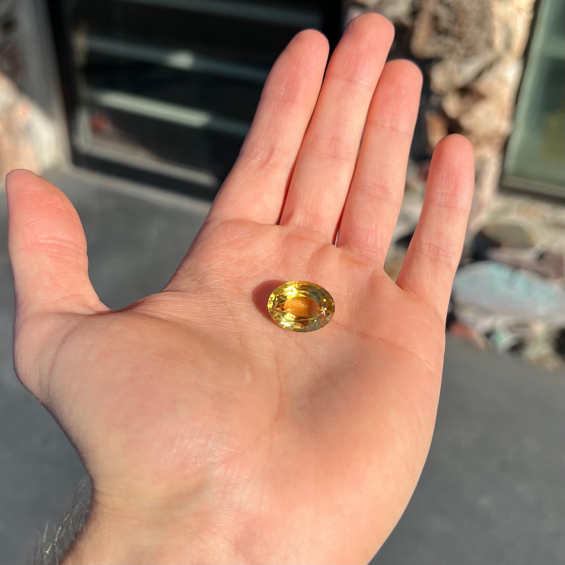 A loose, faceted oval cut golden beryl gemstone.