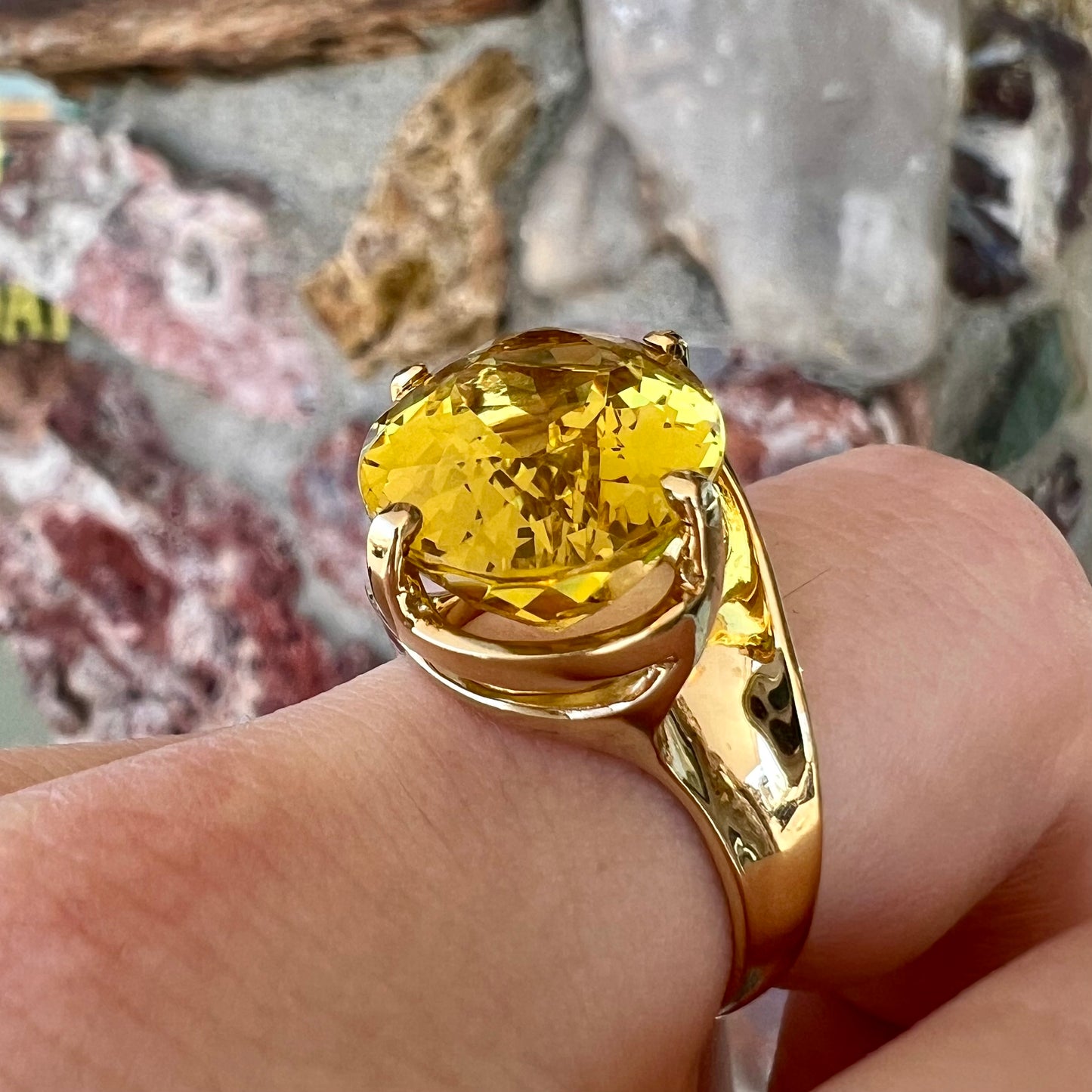 An 18 karat yellow gold solitaire cocktail ring set with a faceted oval cut golden beryl gemstone.