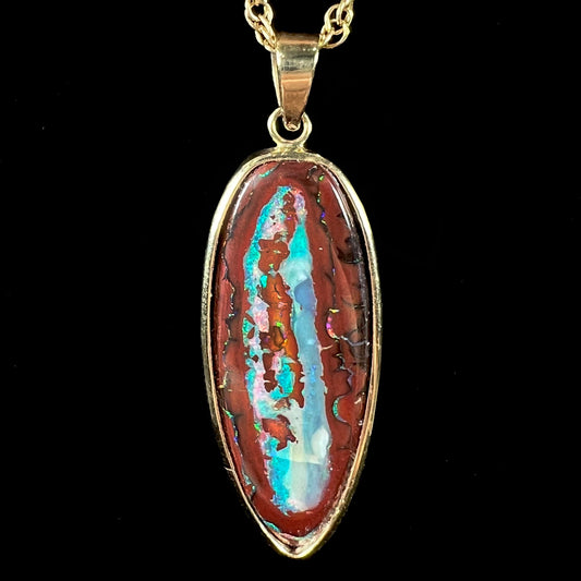 A yellow gold pendant set with a natural Yowah nut boulder opal stone.