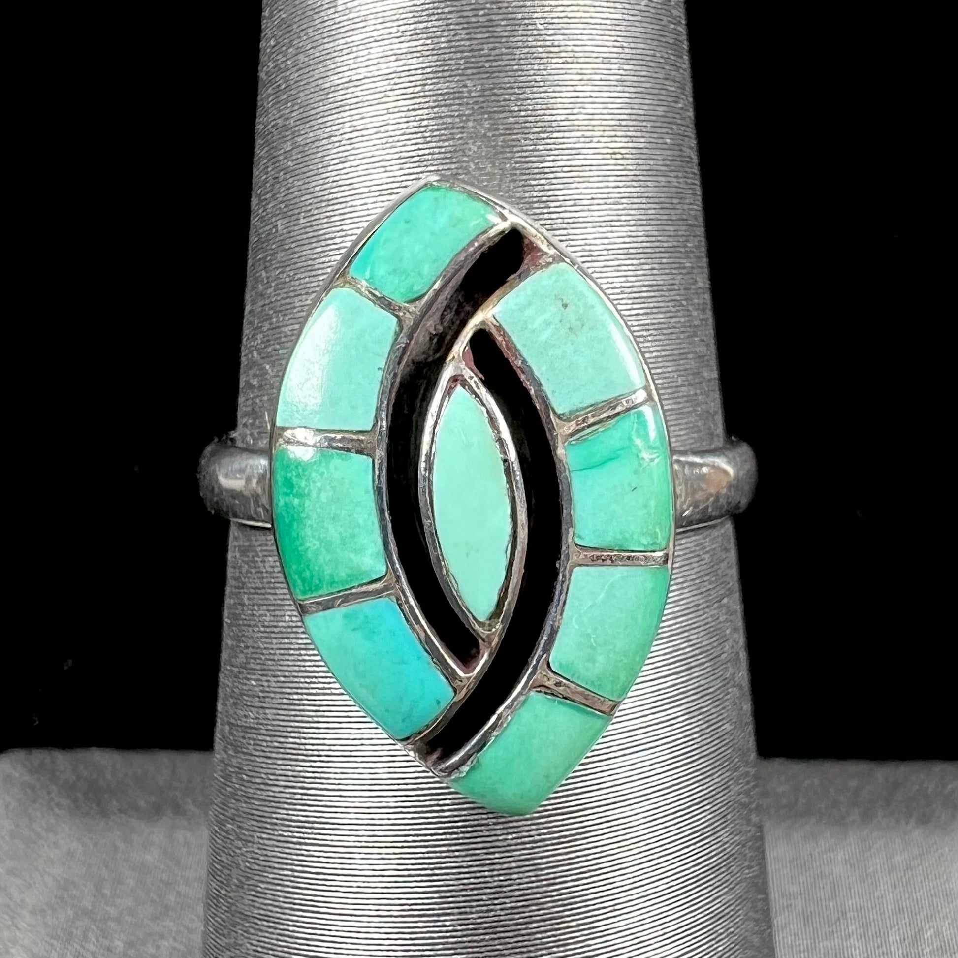 Vintage sterling silver Zuni Indian ring inlay set with green turquoise stones in the motif of a hummingbird.