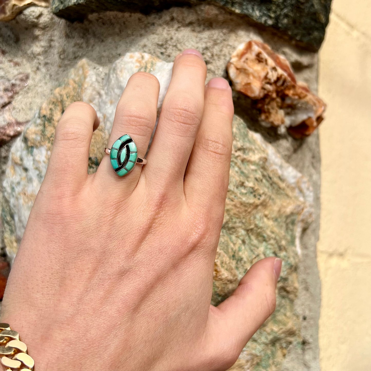 Vintage sterling silver Zuni Indian ring inlay set with green turquoise stones in the motif of a hummingbird.