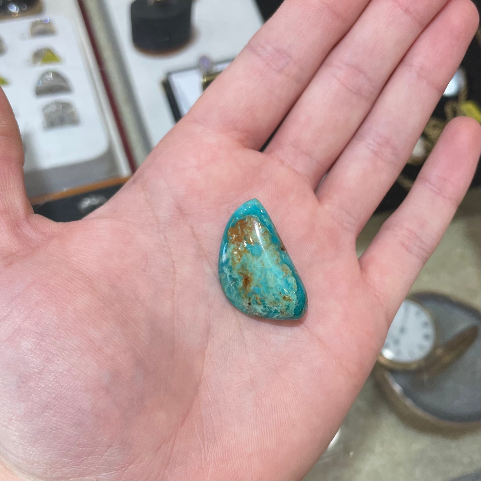 A loose freeform cut turquoise stone from the Royston Mining District in Nevada.
