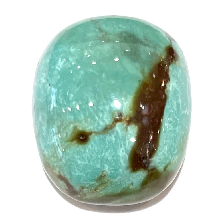 A loose, cushion shaped cabochon cut turquoise stone from Royston District, Nevada.