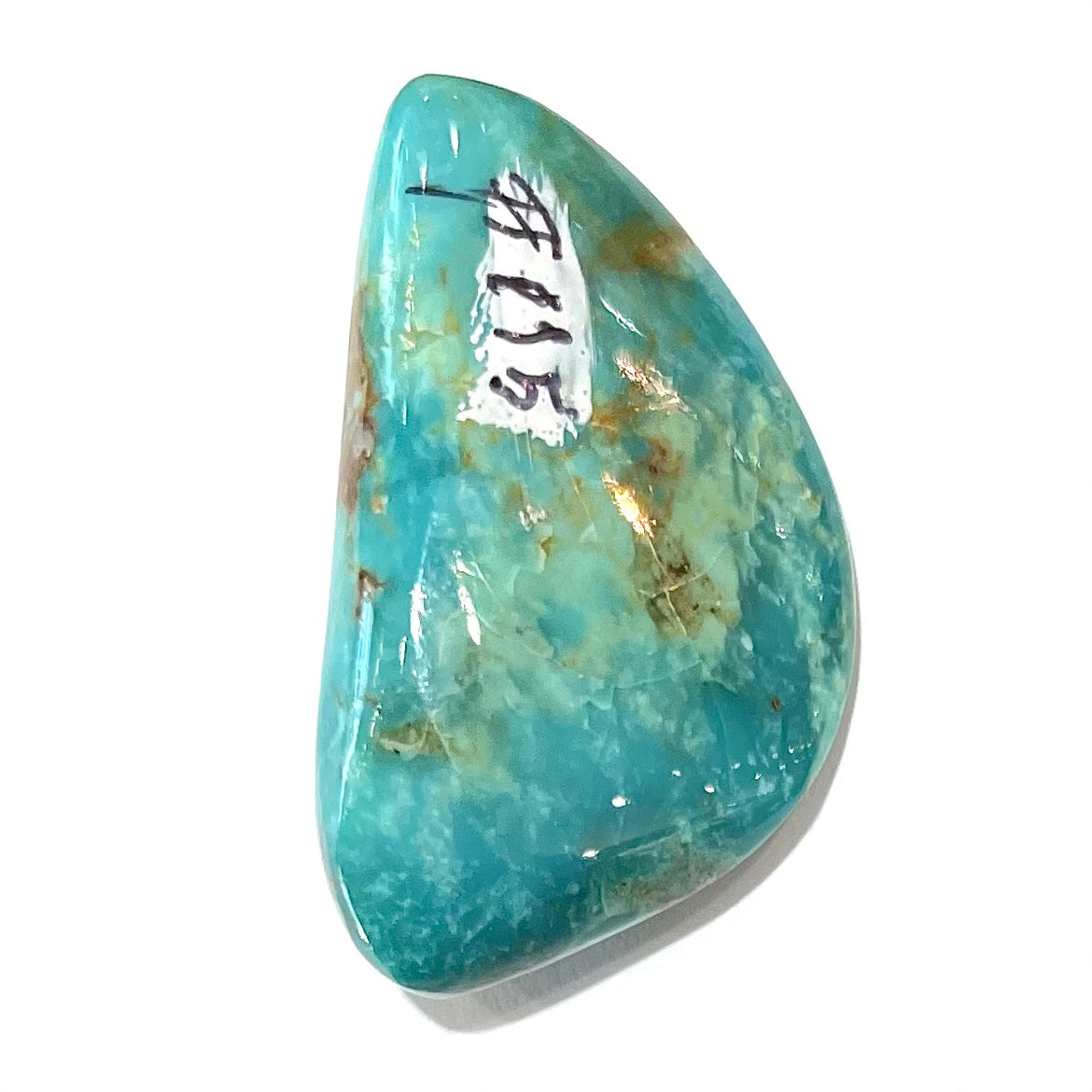 A loose freeform cut turquoise stone from the Royston Mining District in Nevada.