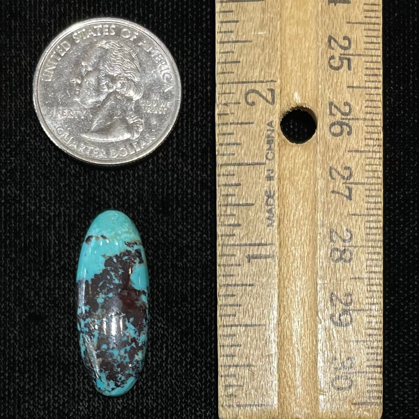 A loose, oval cabochon cut blue and red matrix turquoise stone from Royston District, Nevada.