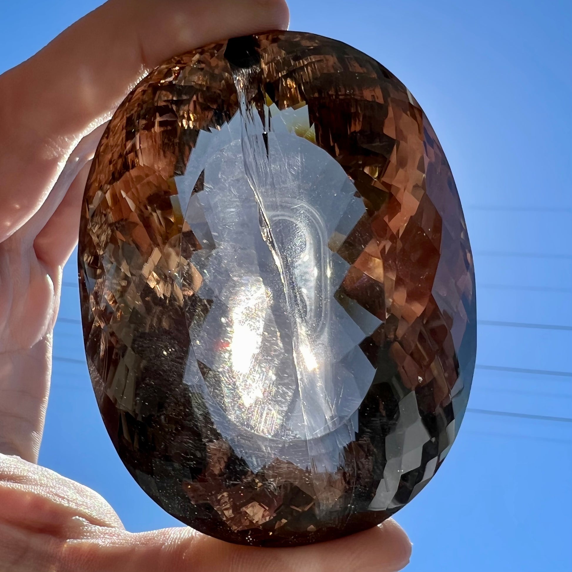 A loose, 1400+ carat smoky quartz gemstone.  The stone has a fracture that runs throughout the stone to the table.
