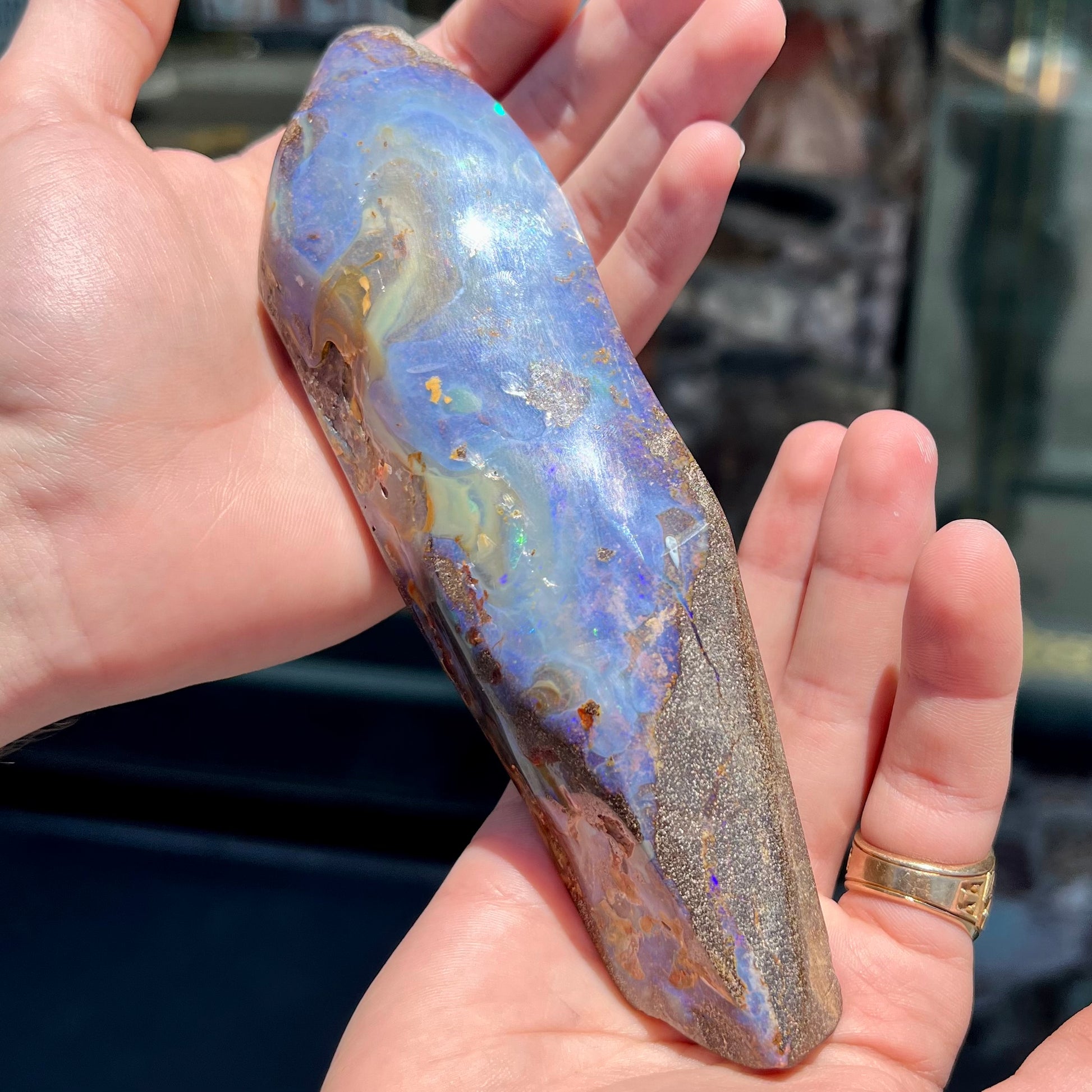 A 7 inch long polished blue Quilpie boulder opal specimen from Queensland, Australia.