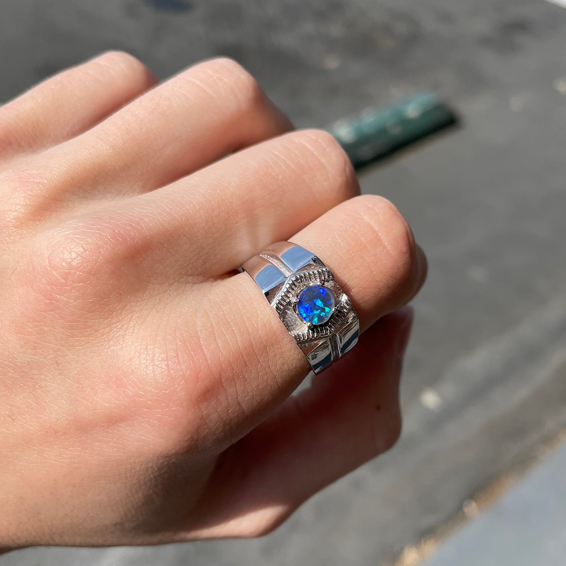 A round black crystal opal solitaire sterling silver men's ring.