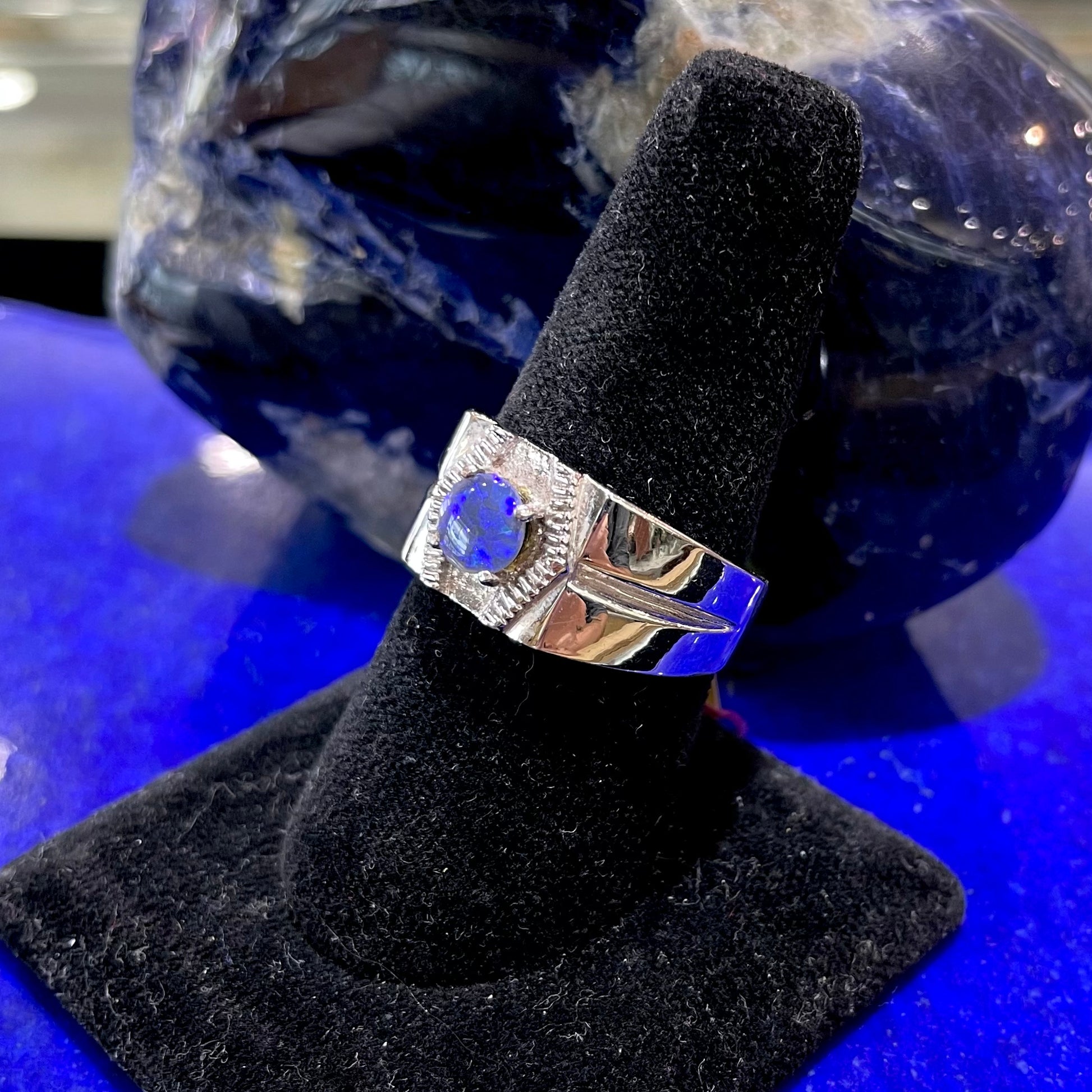 A round black crystal opal solitaire sterling silver men's ring.