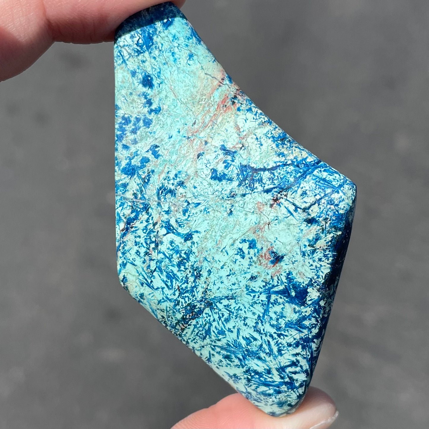 A freeform shape, polished azurite in turquoise stone.