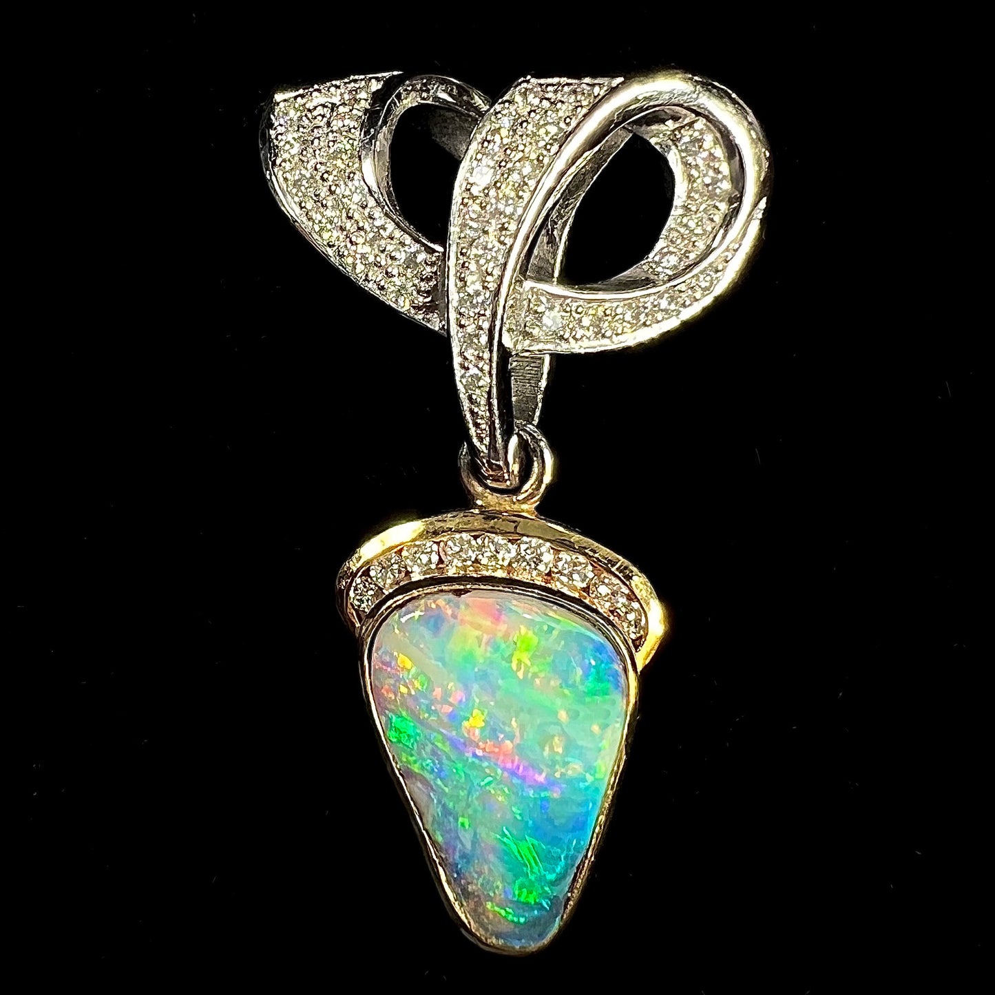 A ladies' 18kt two tone white and yellow gold Australian black boulder opal and diamond pendant.