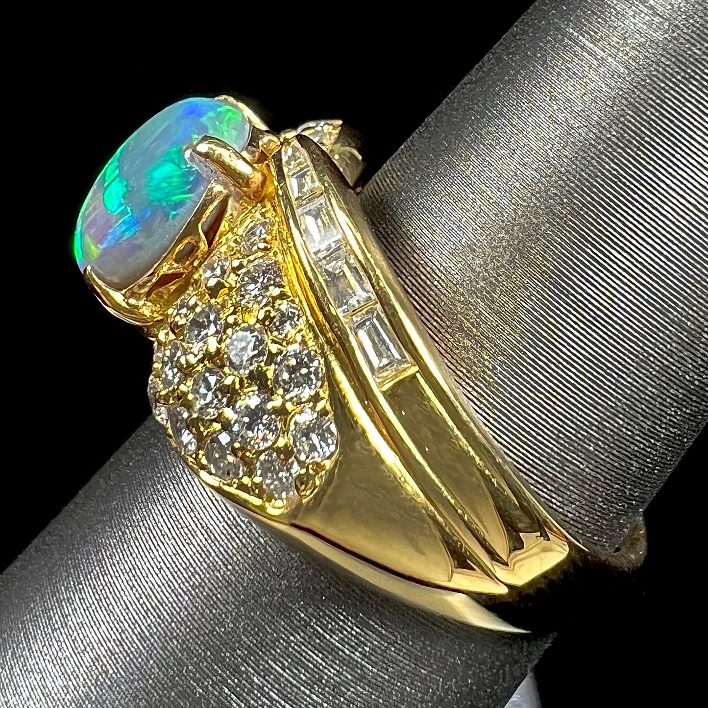 A natural, Australian black opal and diamond ring cast in 18 karat yellow gold..