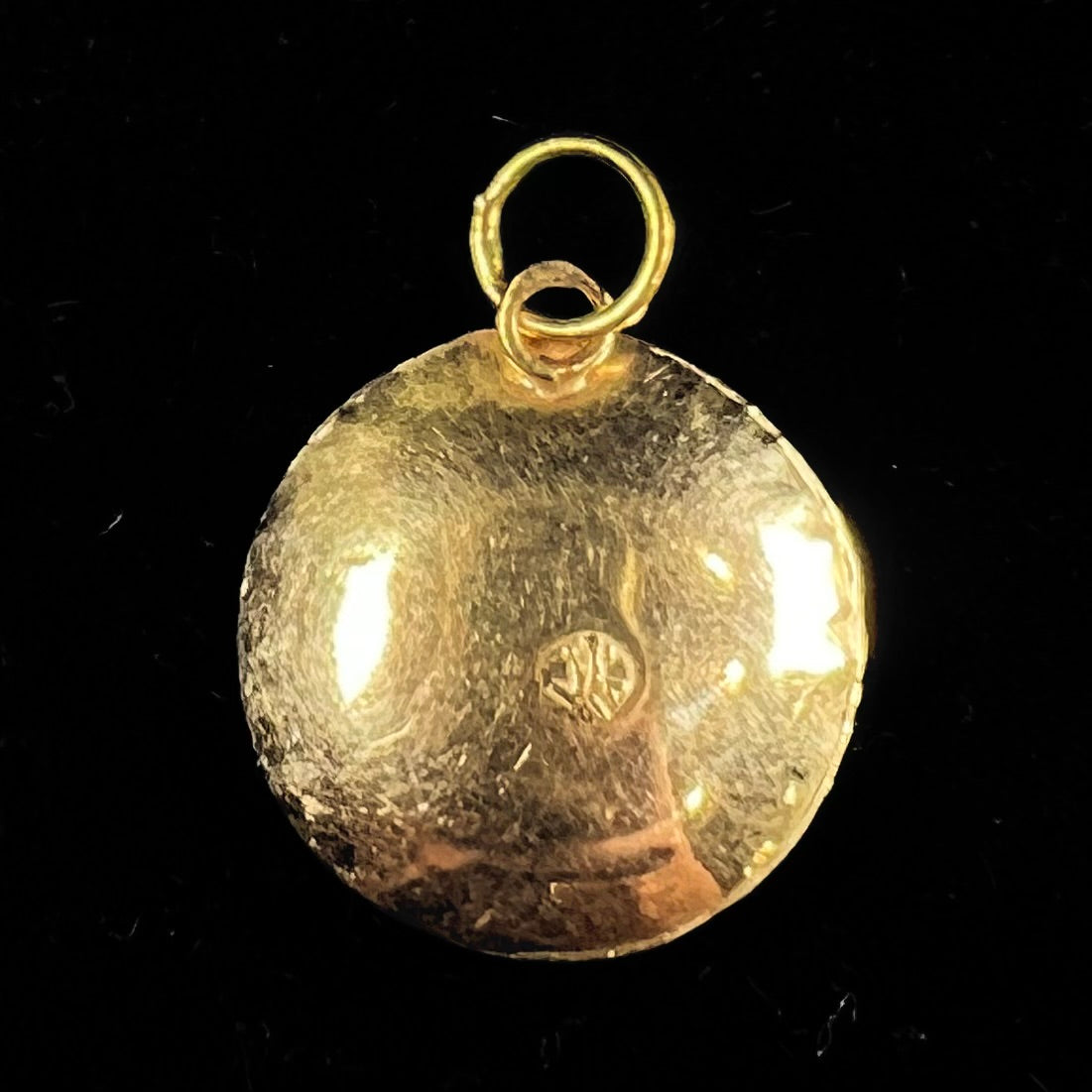 An 18kt yellow gold all-seeing eye pendant with a moving glass eye.