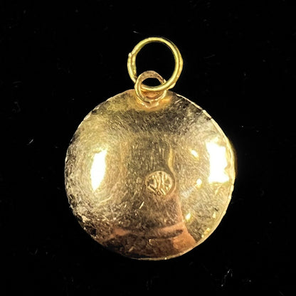 An 18kt yellow gold all-seeing eye pendant with a moving glass eye.