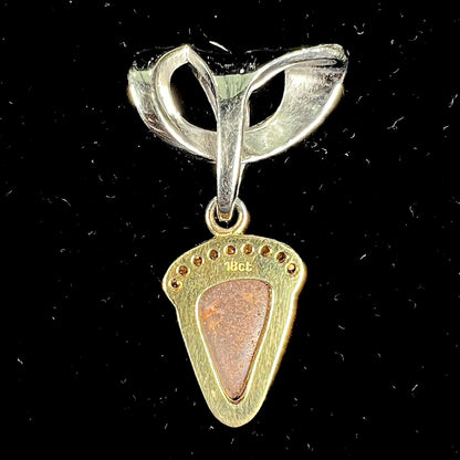 A ladies' 18kt two tone white and yellow gold Australian black boulder opal and diamond pendant.