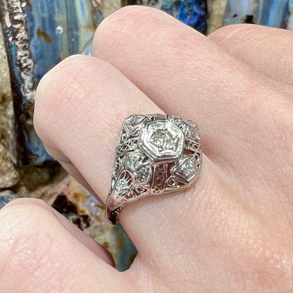 An antique ladies' platinum diamond filigree engagement ring.  The center stone is an old European cut diamond.